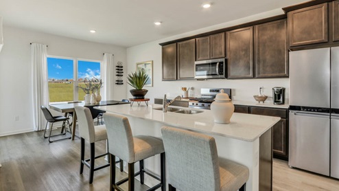 Large Kitchen with 42 inch flagstone cabinets, crown moulding, and white quartz countertops