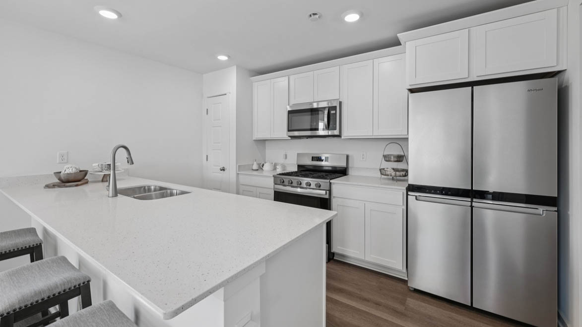 open concept kitchen with white cabinetry