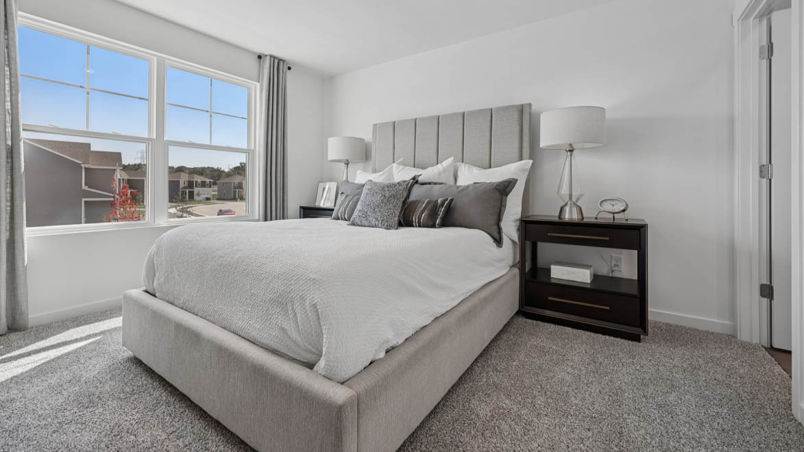 primary bedroom with large window and natural light