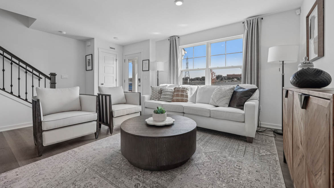 spacious living room with large windows and natural light