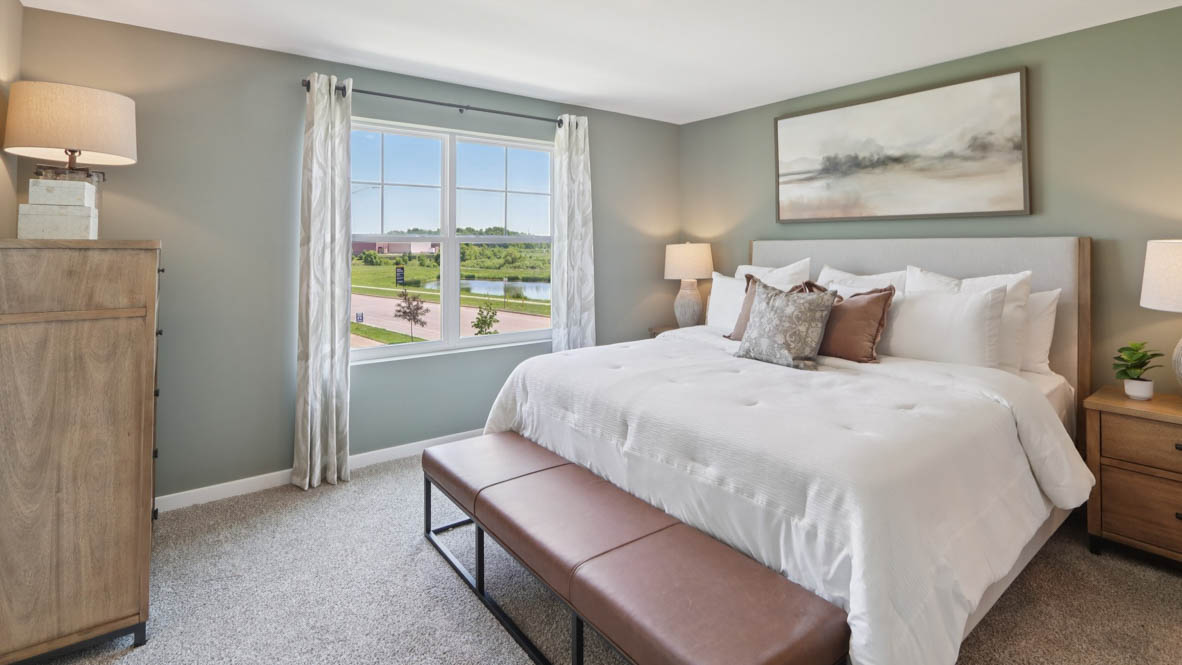 primary bedroom with carpet and large window view