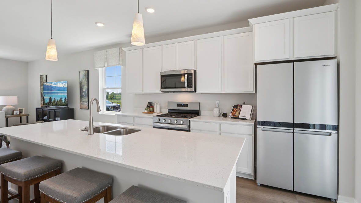 open concept kitchen with spacious island and white cabinets