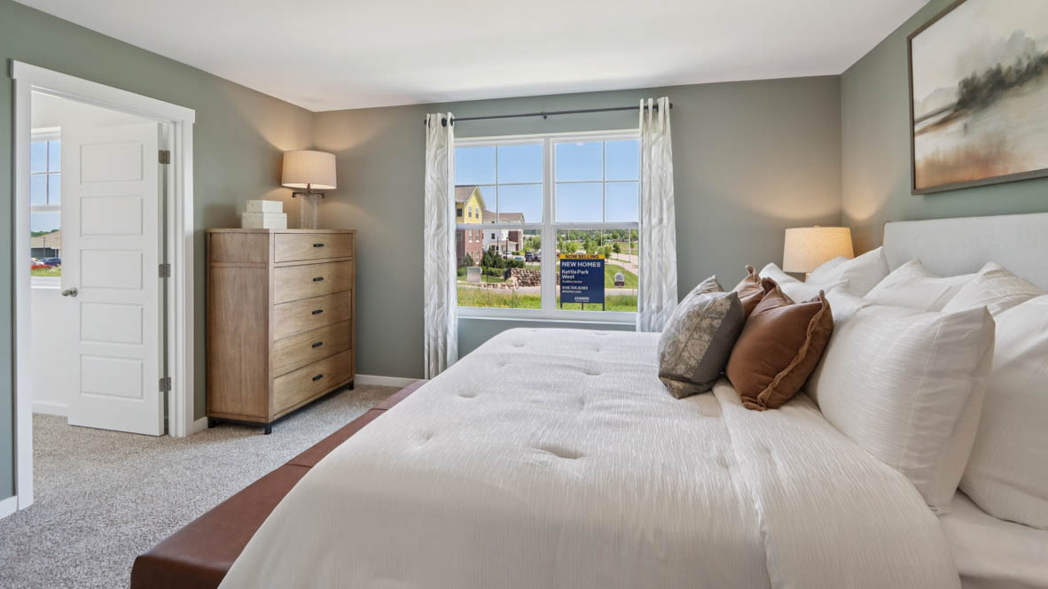 primary bedroom with carpet and large window view