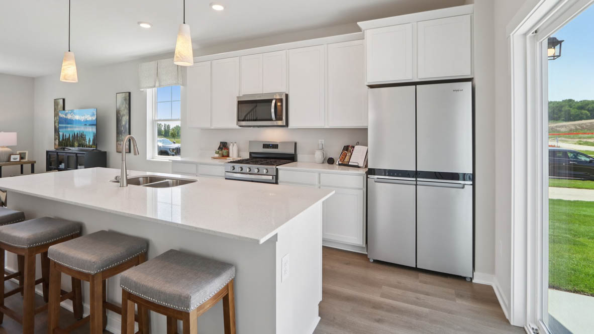 Interior kitchen with center island and white cabinets