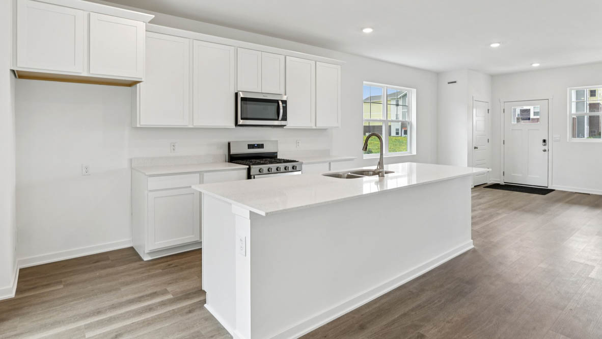 Kitchen with large kitchen island overlooking dining room