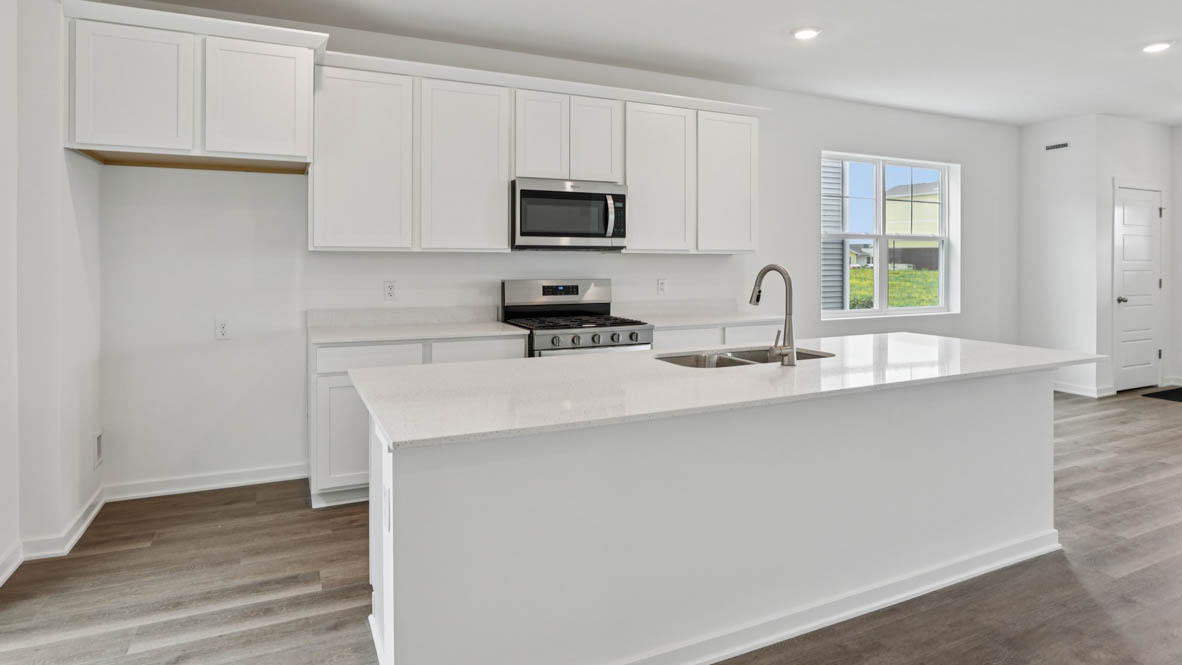 kitchen with white cabinets and white quartz countertops