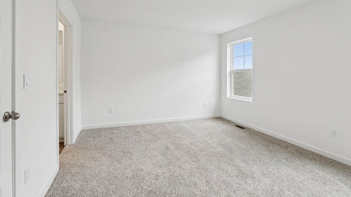 Primary bedroom with connecting en suite and walk in closet