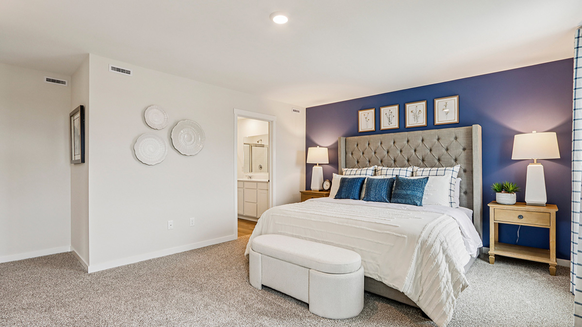 primary bedroom with carpet and large window view