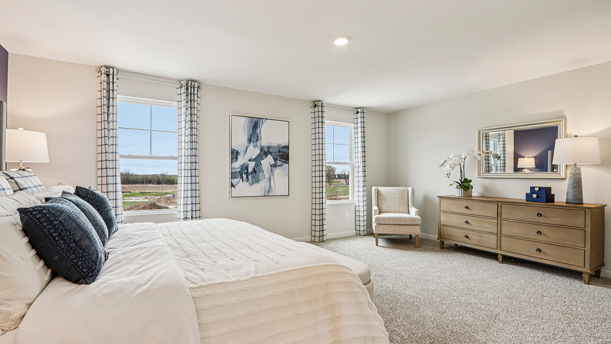 primary bedroom with carpet and large window view