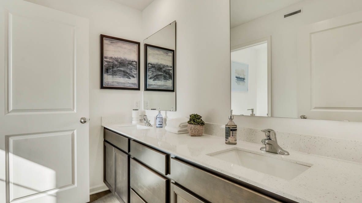 Secondary full bathroom with dual sinks