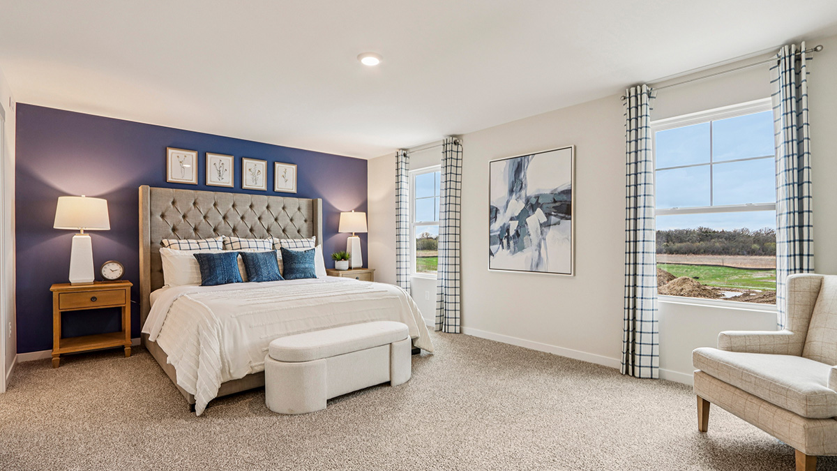 primary bedroom with carpet and large window view