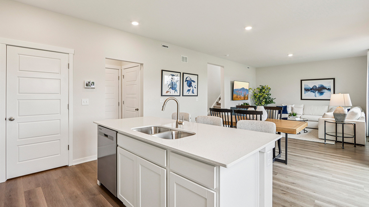 open concept kitchen with spacious island and white cabinets