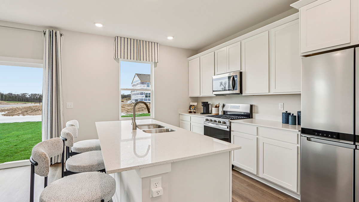 open open concept kitchen with stainless steel appliancesconcept kitchen with spacious island and white cabinets