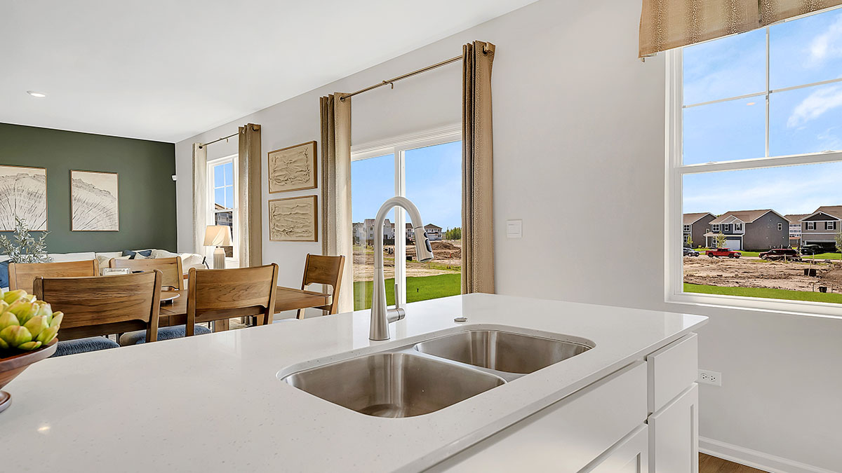 Large kitchen island overlooking great room and dining room