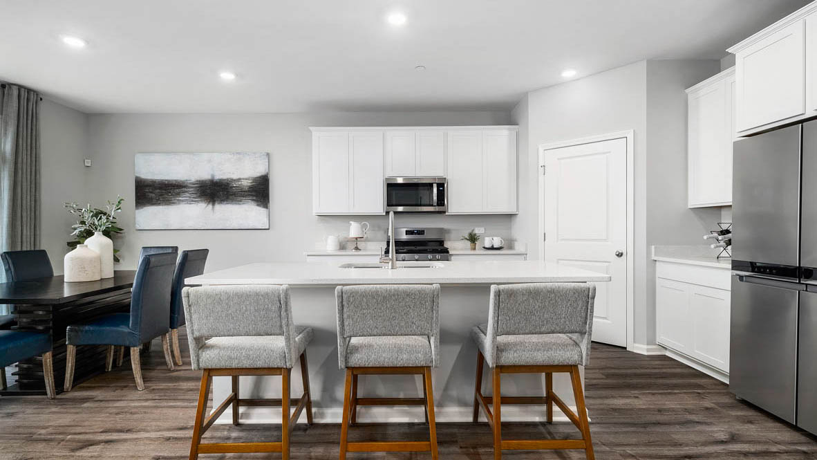 open concept kitchen with spacious island and white cabinets