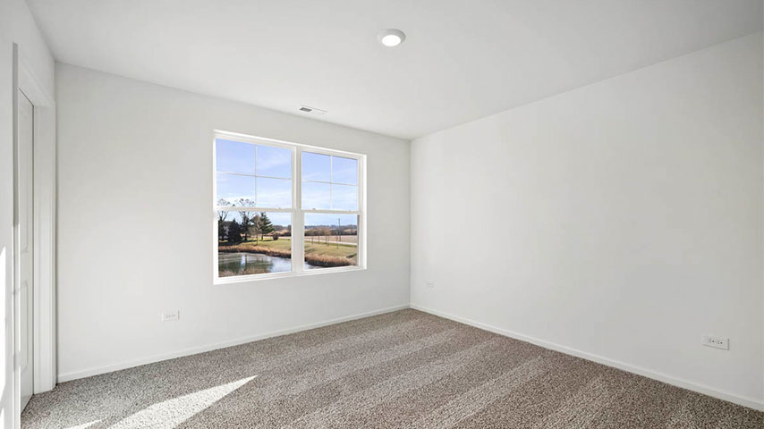 secondary bedroom with carpeted flooring