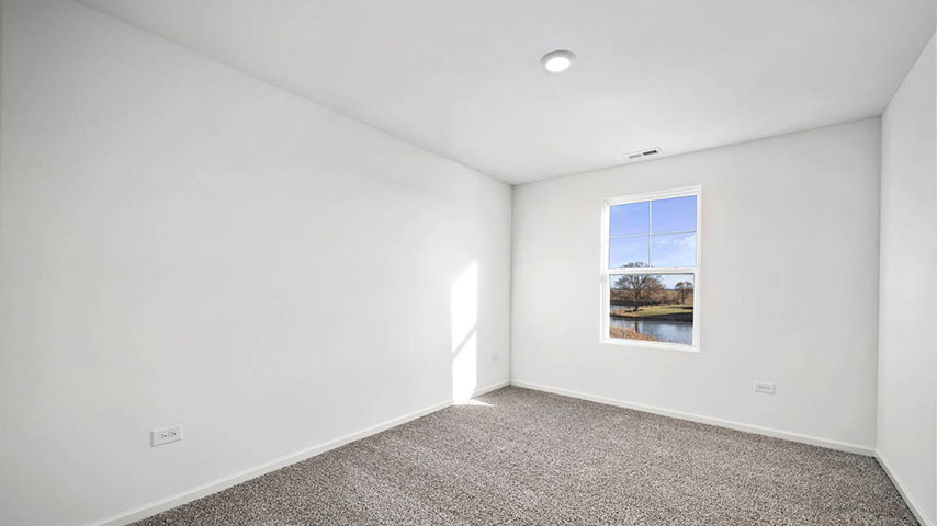 secondary bedroom with carpeted flooring