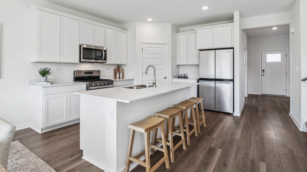 open concept kitchen with spacious island and white cabinets