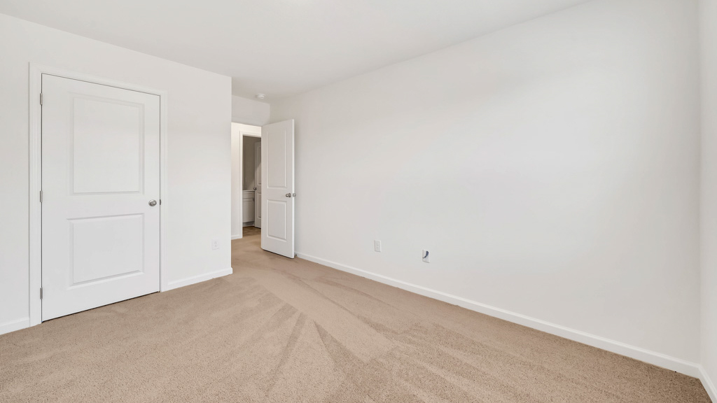 Bedroom with ample natural light and plush carpet floors