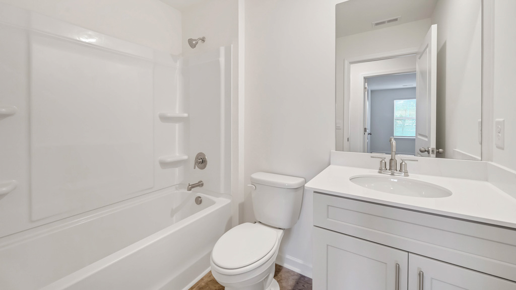 Upstairs guest bathroom with combination shower and bathtub