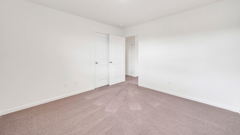 Bedroom with ample natural light and plush carpet floors