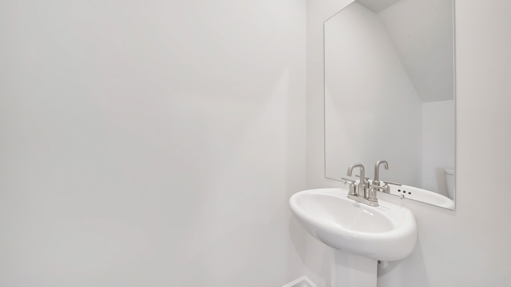 Downstairs guest half bathroom with pedestal sink