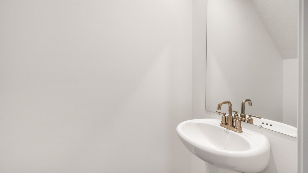 Downstairs guest bathroom with pedestal sink