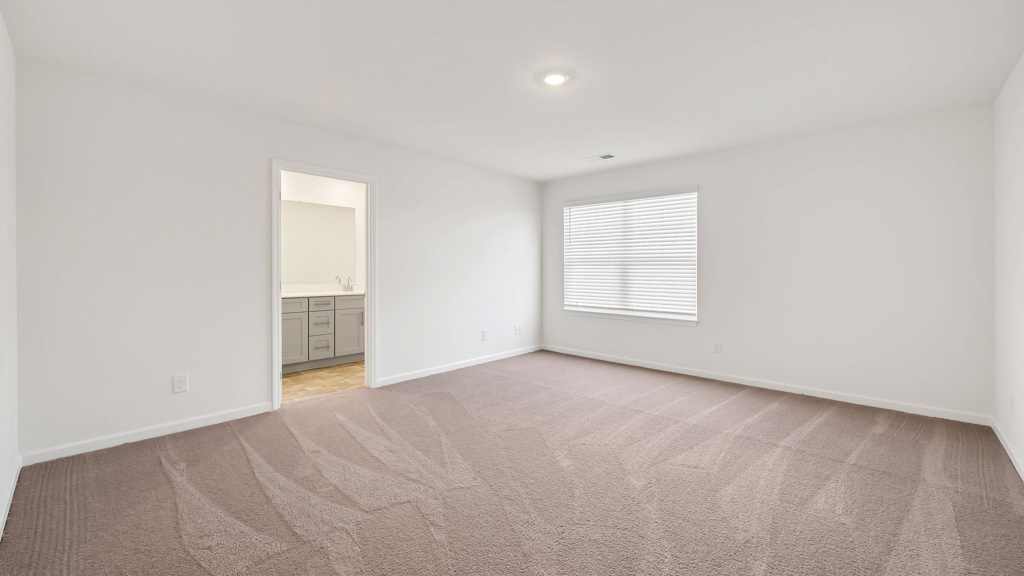 Bedroom with ample natural light and plush carpet floors