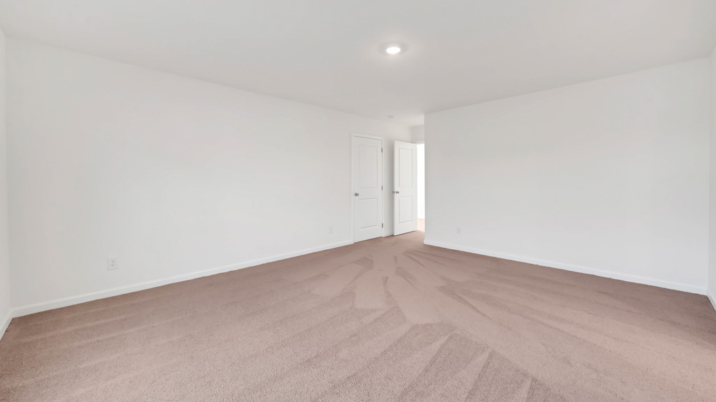 Bedroom with ample natural light and plush carpet floors