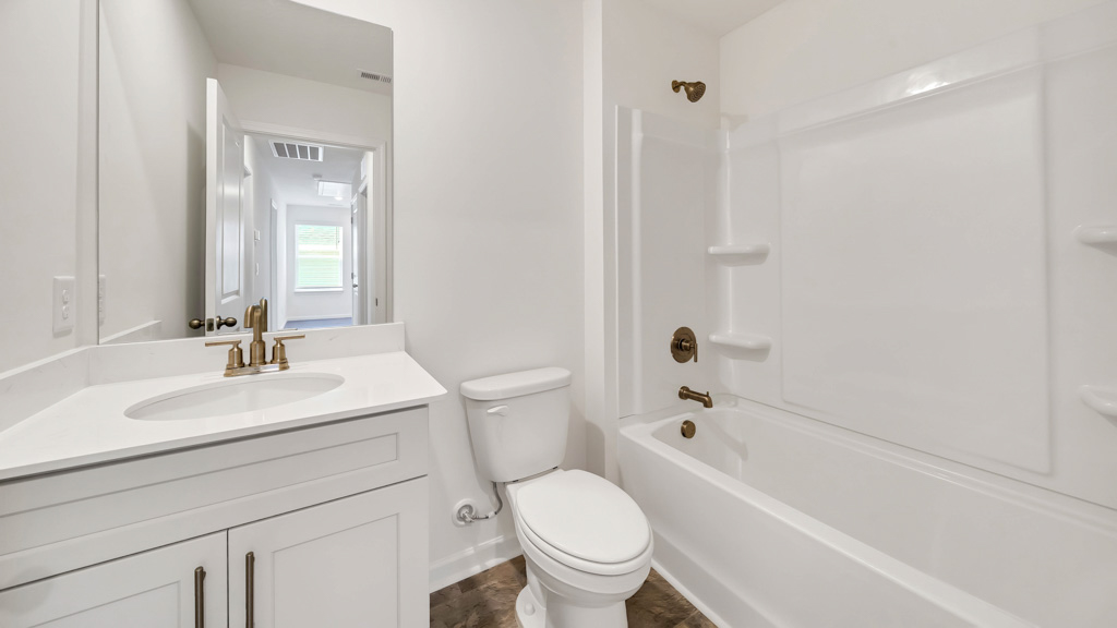 Upstairs guest bathroom with combination shower and bathtub