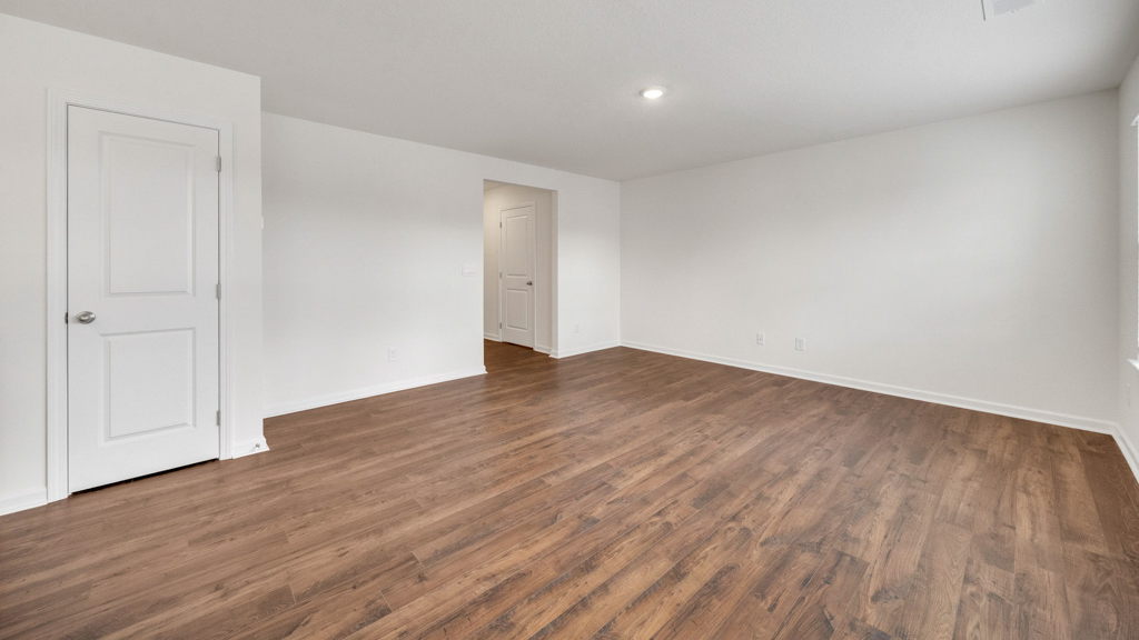 Spacious living and great  room space with light allowing windows