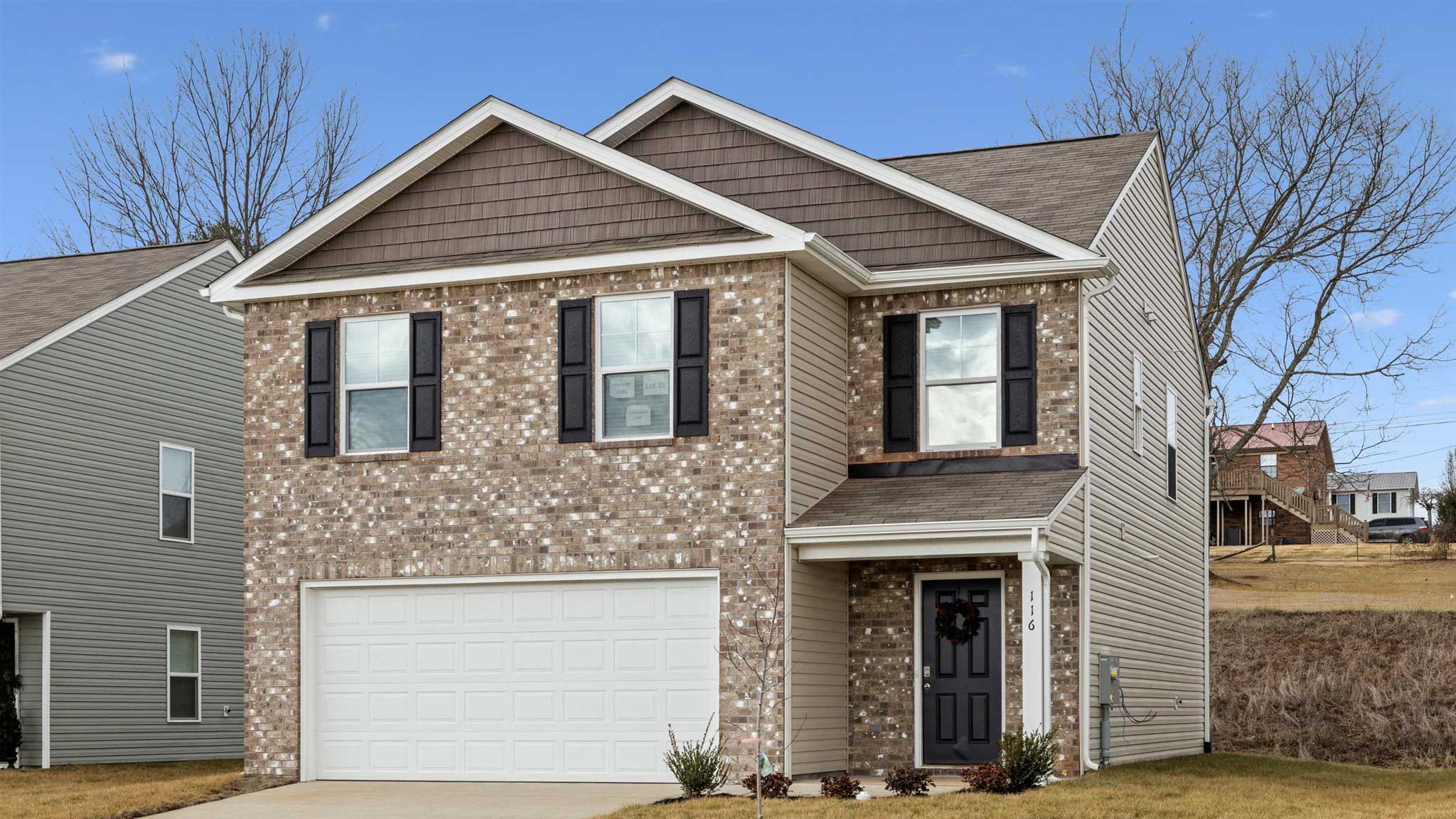 Edmon plan is a two story home with two car garage and side door.
