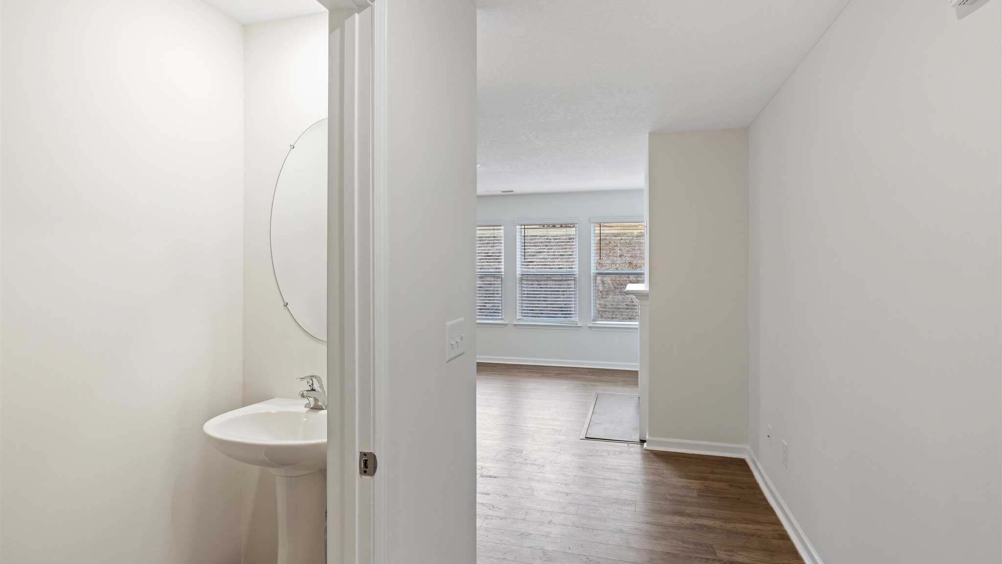 hallway with hard flooring and white walls