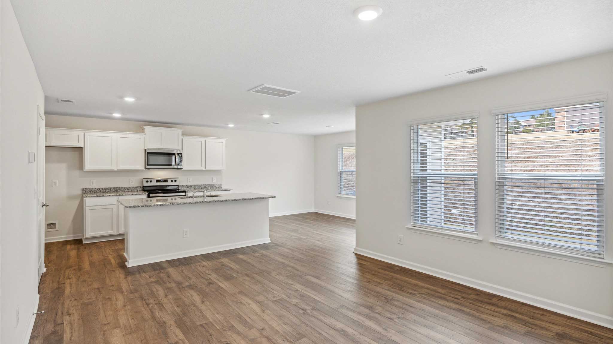Kitchen with appliances and granite countertops.