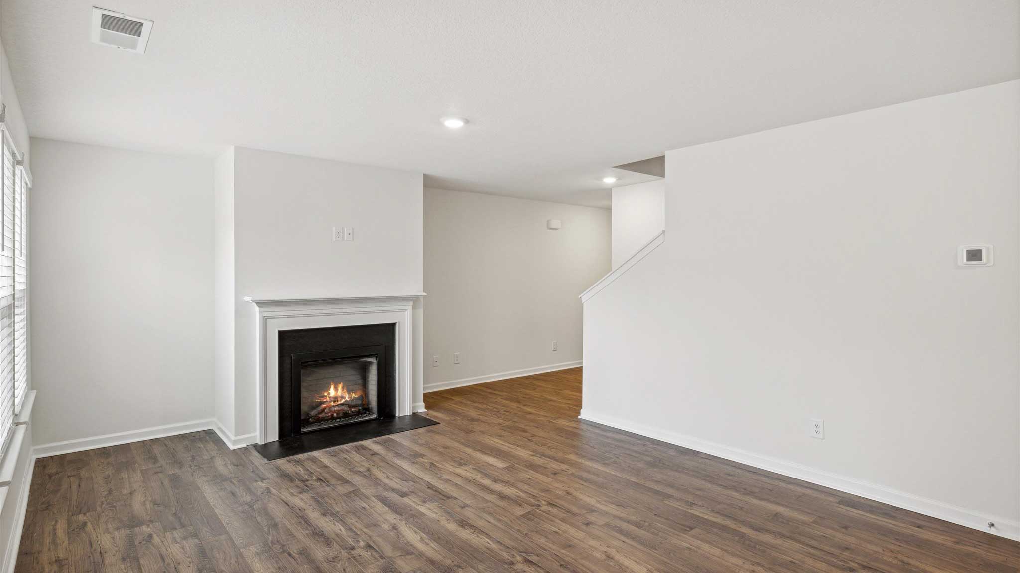 Living area with fireplace and hard flooring.