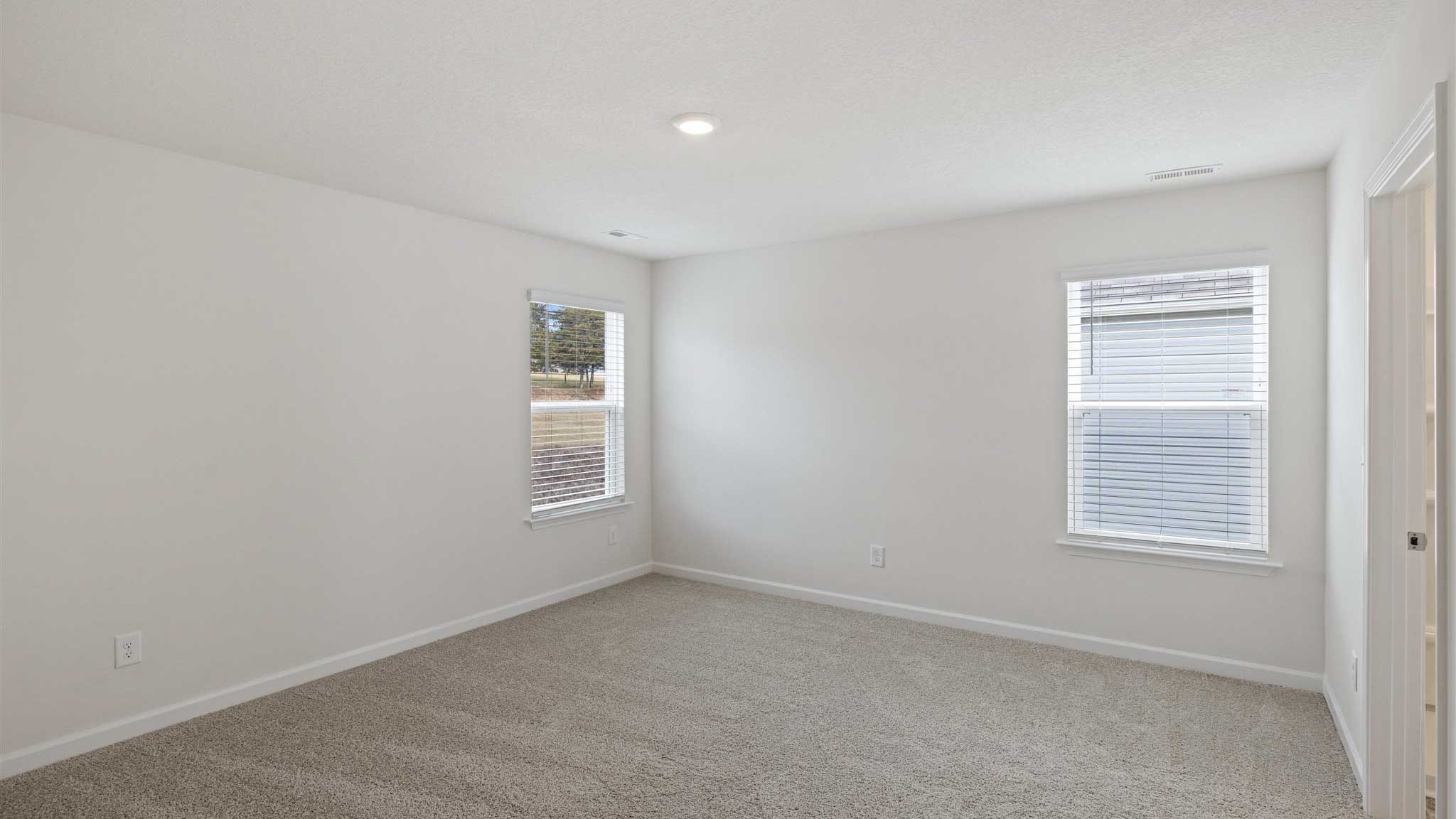 Bedroom with white waslla nd window.