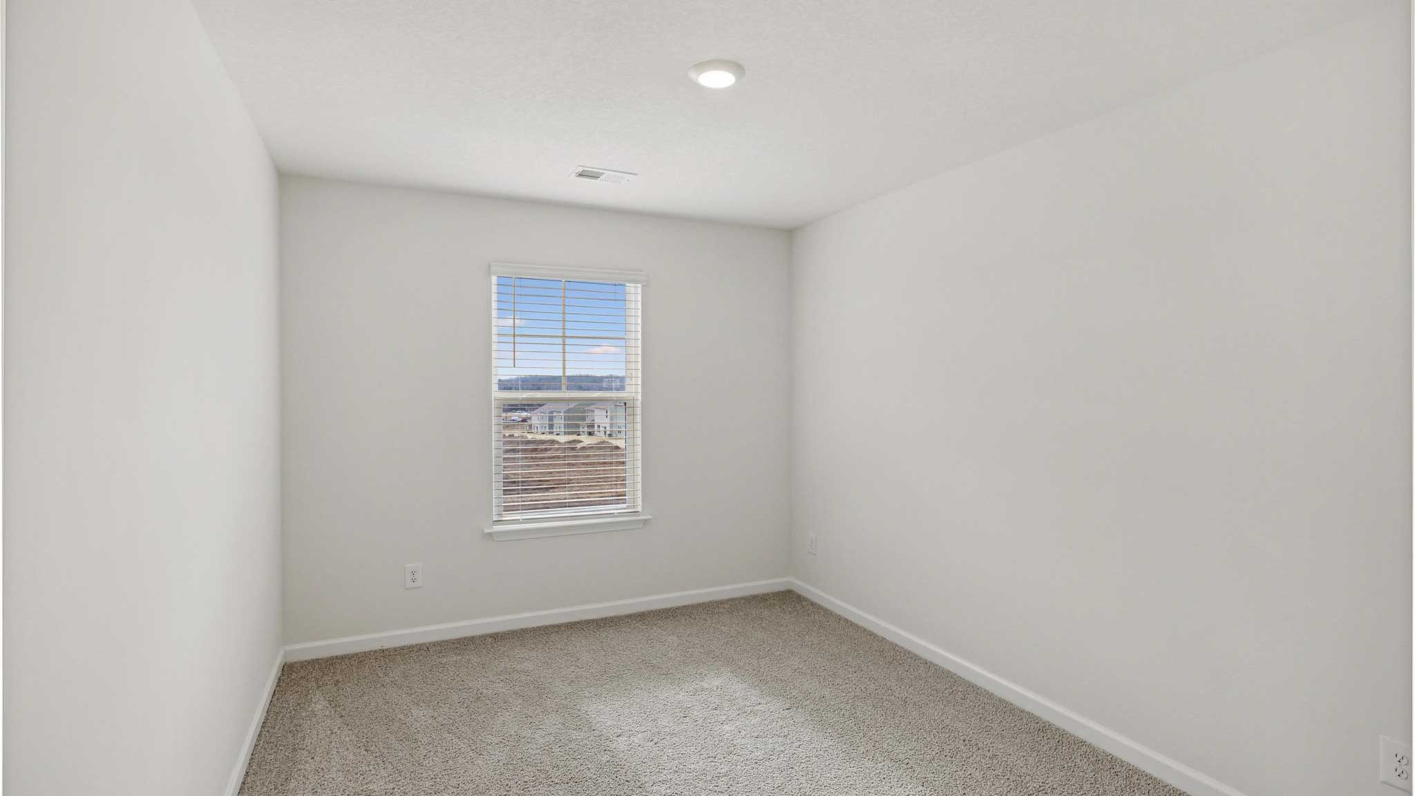 Bedroom with white waslla nd window.