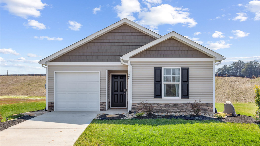 Single Story home with water table, garage and driveway.