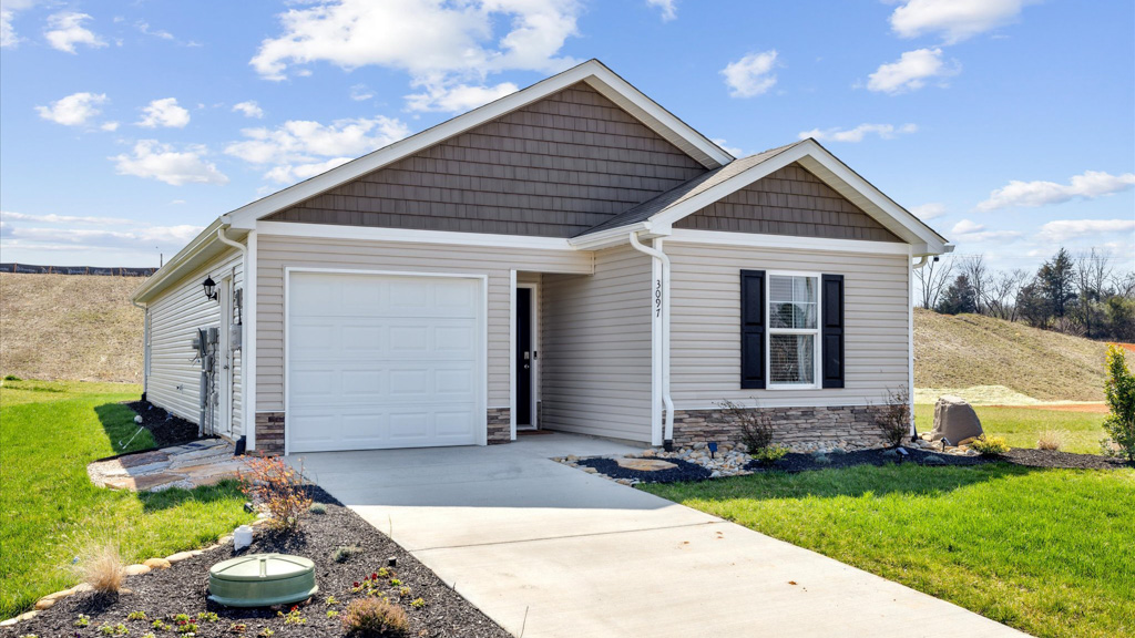 Single Story home with water table, garage and driveway.