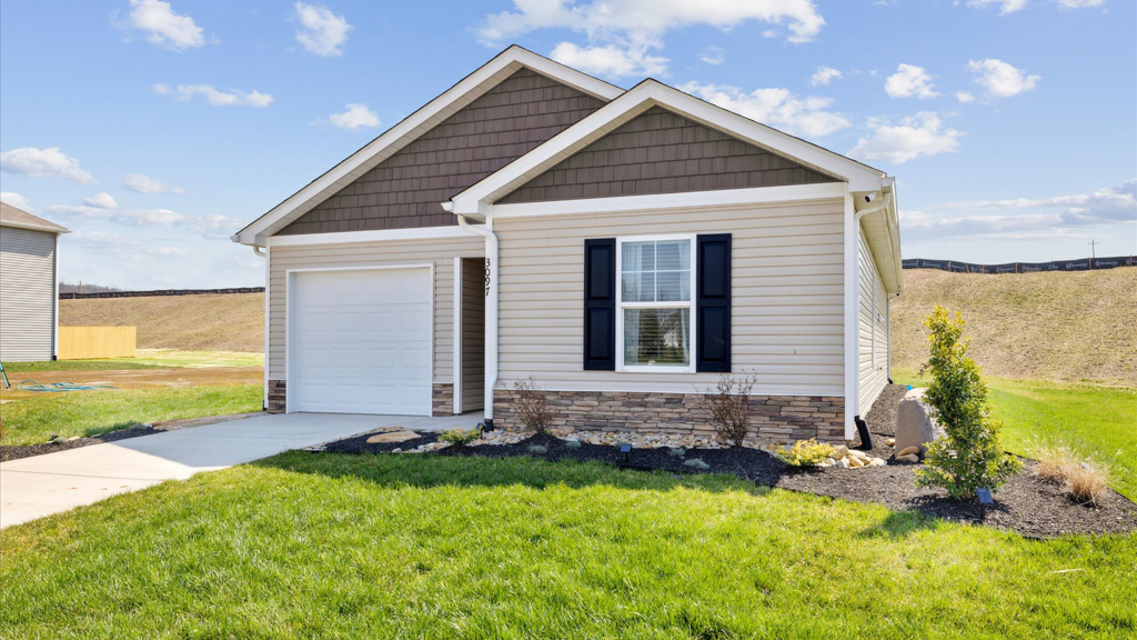 Single Story home with water table, garage and driveway.