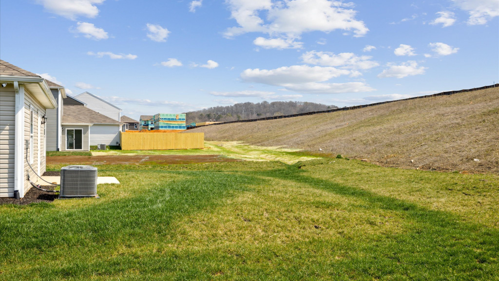 Exterior shot of the home from the side showing beautiful grass scape.