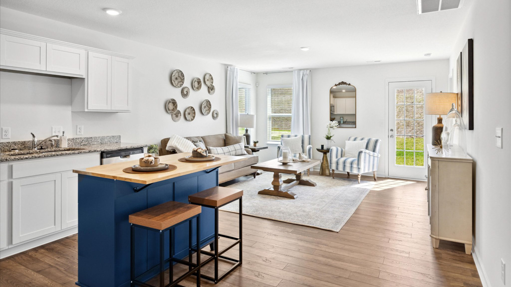 Kitchen with island and opens into the living room.