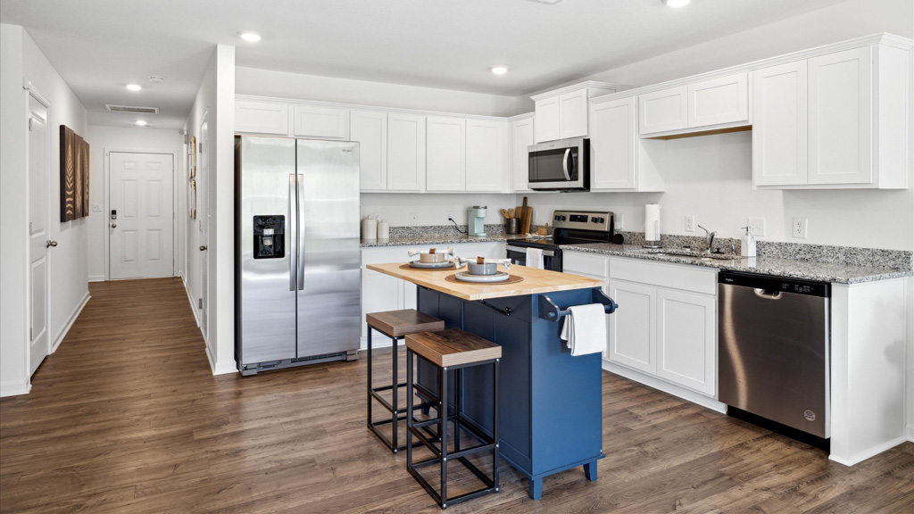 Kitchen with island and stainless appliance.