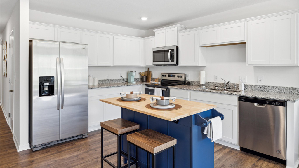 Kitchen with island and stainless appliance.