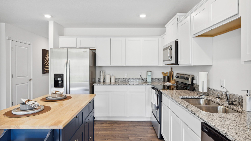 Kitchen with island and stainless appliance.