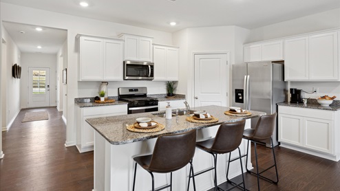 Kitchen with island and countertop seating