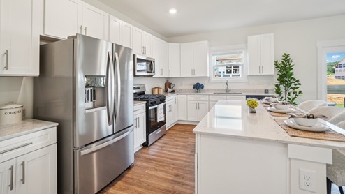 Interior kitchen with appliances and central island with sink