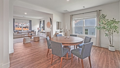 Interior dining room with two large windows open to living room