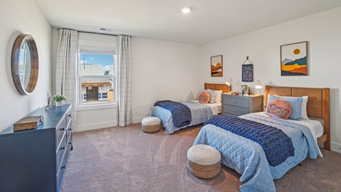 Interior bedroom with two beds and natural lighting