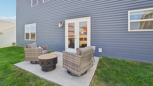 Richland plan exterior patio with fire pit and chairs